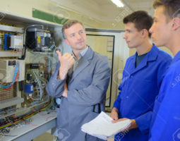 Man showing equipment to two apprentices